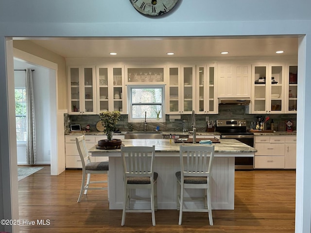 kitchen featuring electric stove, dishwasher, sink, and white cabinets