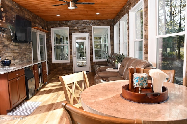 sunroom featuring wooden ceiling and ceiling fan