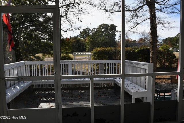 view of yard featuring a deck, a patio area, and a sunroom