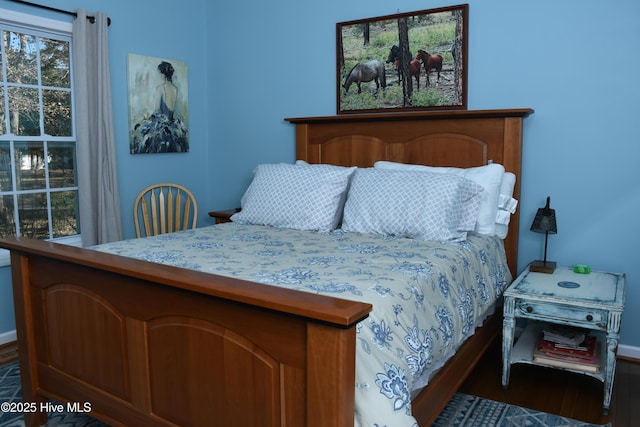 bedroom with dark wood-type flooring