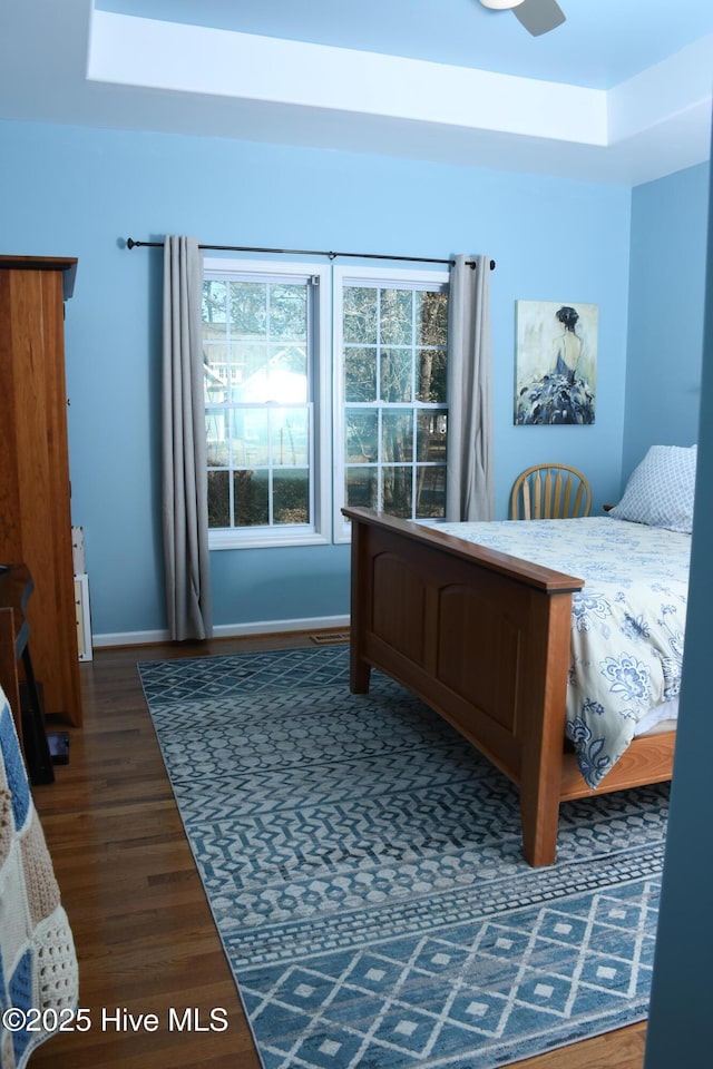 bedroom with dark hardwood / wood-style flooring