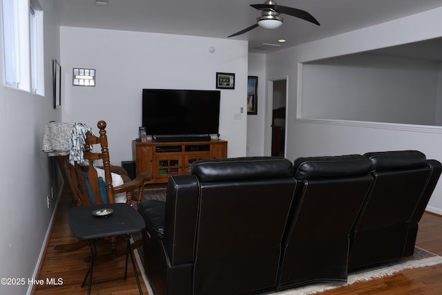 living room featuring ceiling fan and hardwood / wood-style floors