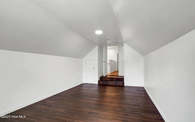 bonus room featuring dark hardwood / wood-style flooring and vaulted ceiling