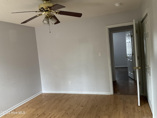 unfurnished room with hardwood / wood-style flooring and ceiling fan