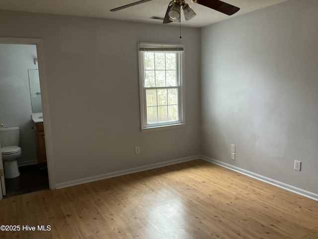 unfurnished room with light wood-type flooring and ceiling fan