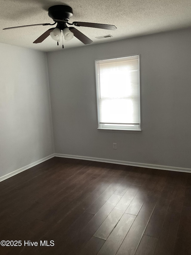 spare room featuring a textured ceiling, dark hardwood / wood-style floors, and ceiling fan