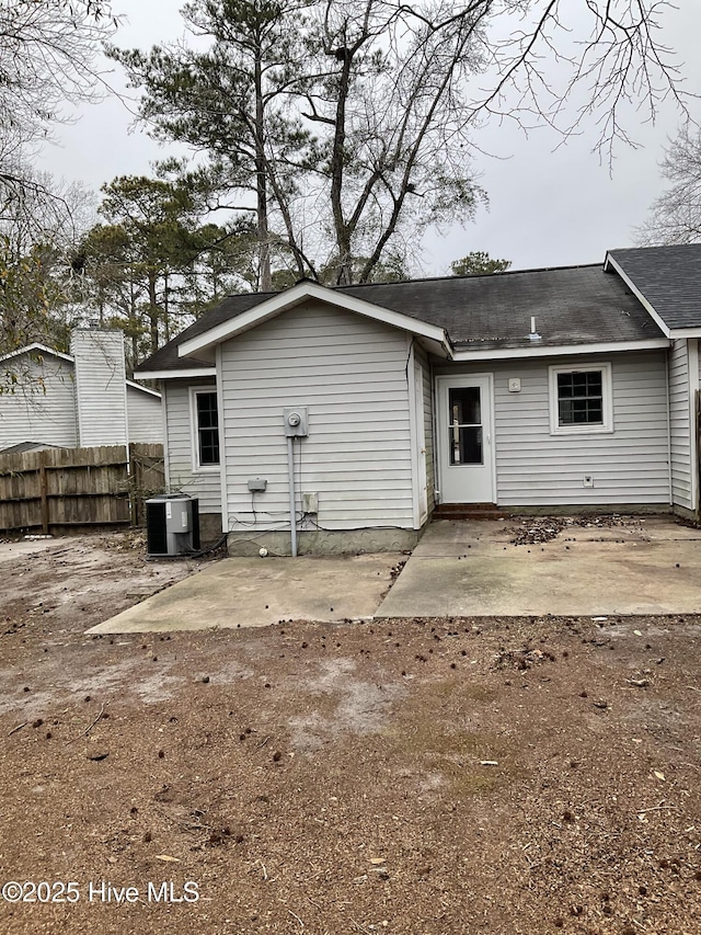 rear view of house featuring central air condition unit and a patio