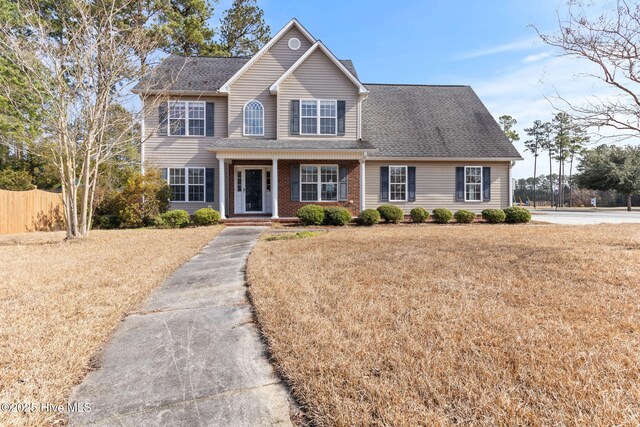 view of front of house featuring a front yard and covered porch