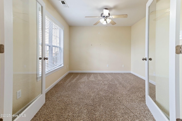 spare room with ceiling fan and carpet floors