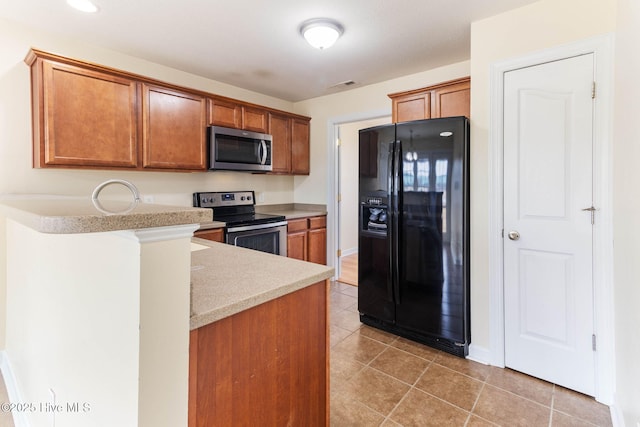 kitchen with appliances with stainless steel finishes and light tile patterned floors