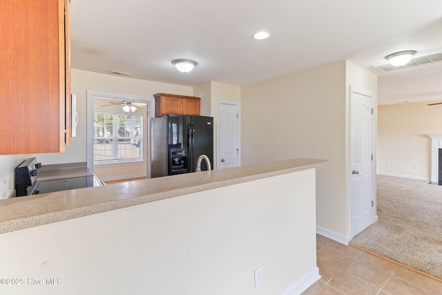 kitchen with light carpet, stainless steel electric range, black refrigerator with ice dispenser, and ceiling fan