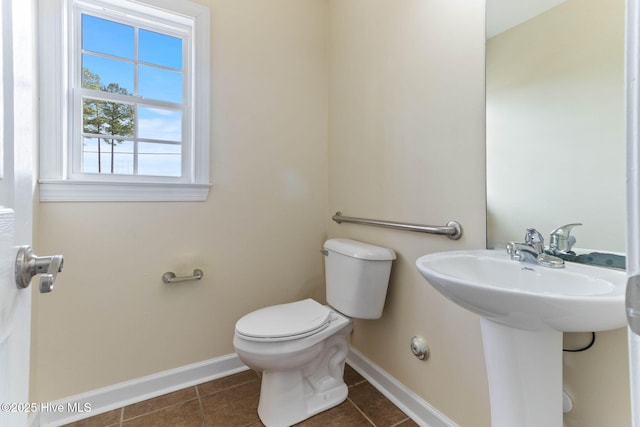 bathroom with tile patterned floors, toilet, and sink