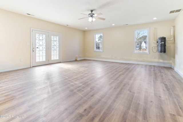 unfurnished room with ceiling fan and light wood-type flooring