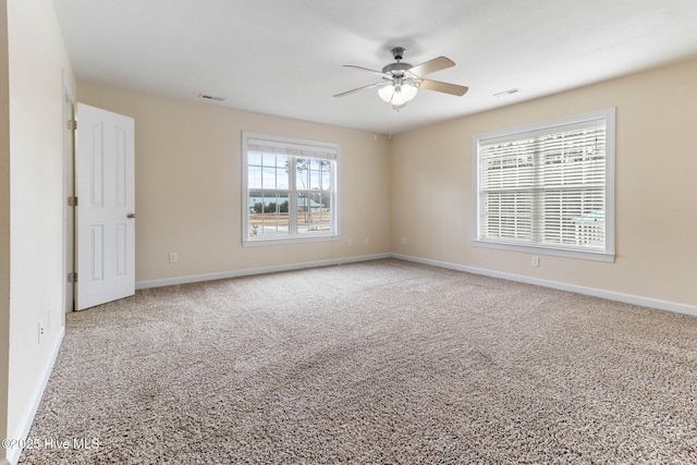 carpeted spare room featuring ceiling fan