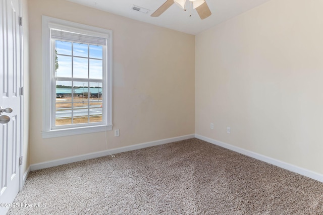 empty room featuring carpet flooring and ceiling fan