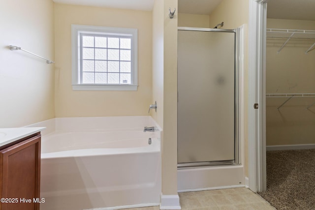 bathroom with independent shower and bath and vanity