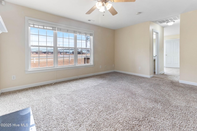 carpeted spare room with ceiling fan