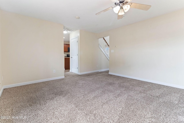 carpeted spare room featuring ceiling fan