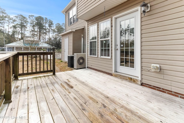 wooden terrace featuring ac unit and central AC