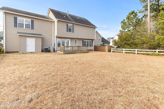 back of house with a wooden deck, a yard, and central AC