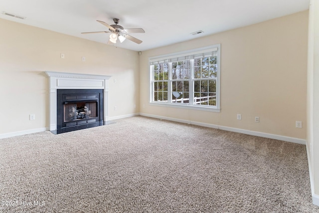 unfurnished living room with ceiling fan and carpet floors