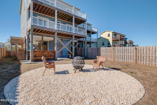 back of property with a patio area and a fire pit