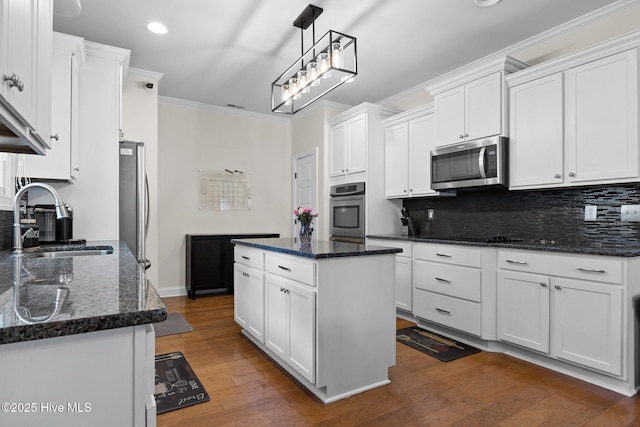 kitchen featuring white cabinets, a center island, sink, and stainless steel appliances