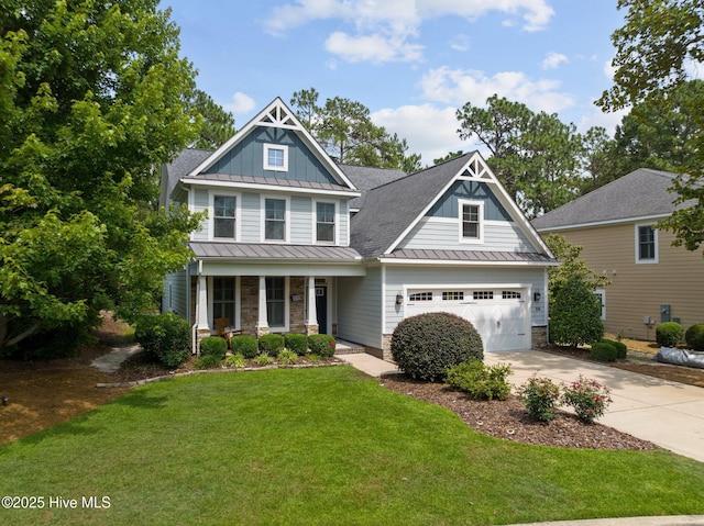 craftsman-style home with covered porch, a garage, and a front lawn