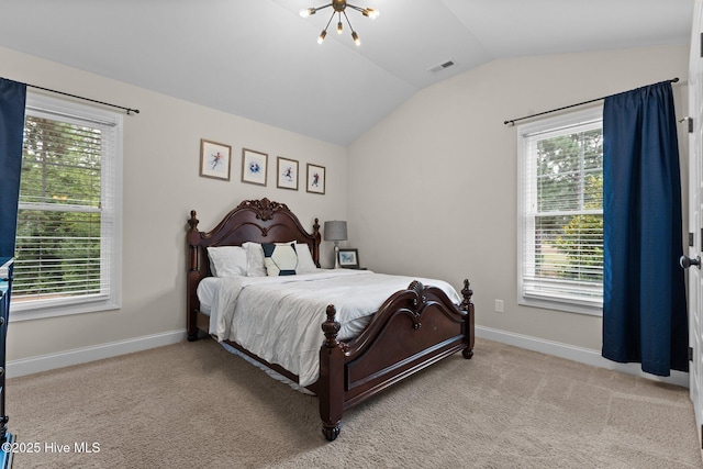 carpeted bedroom featuring a chandelier, multiple windows, and vaulted ceiling