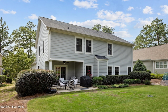 rear view of property with a lawn, a patio area, and ceiling fan