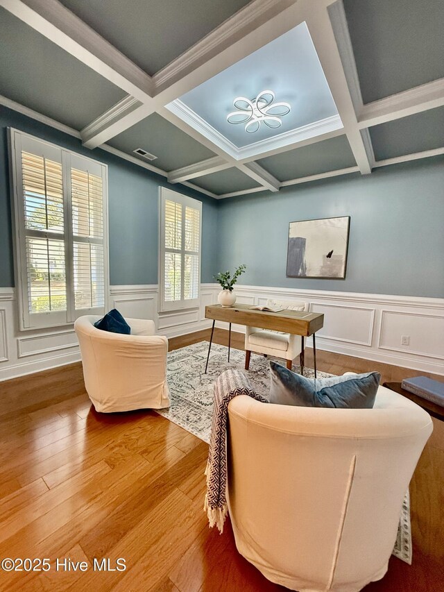 exercise area featuring ornamental molding, hardwood / wood-style flooring, plenty of natural light, and coffered ceiling