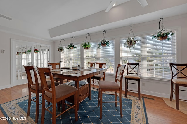 dining area with dark wood-type flooring and ornamental molding