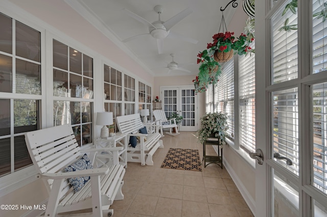 sunroom featuring ceiling fan and french doors