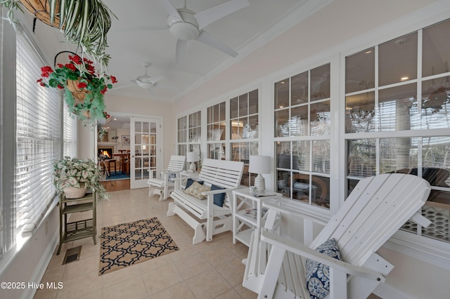 sunroom featuring ceiling fan