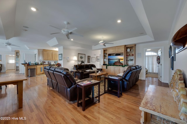 living room featuring ceiling fan and light hardwood / wood-style flooring