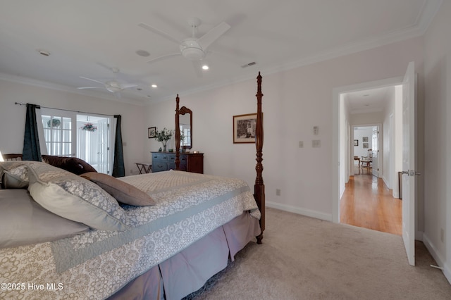 carpeted bedroom with ceiling fan and ornamental molding