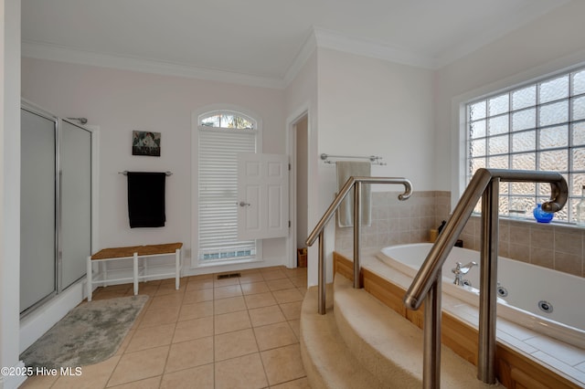 bathroom with tile patterned flooring, crown molding, and shower with separate bathtub