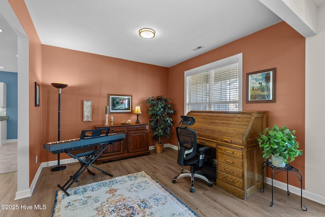 office space with light wood-type flooring