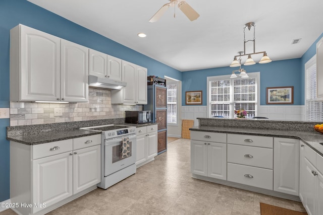 kitchen featuring ceiling fan, decorative backsplash, electric stove, hanging light fixtures, and white cabinets