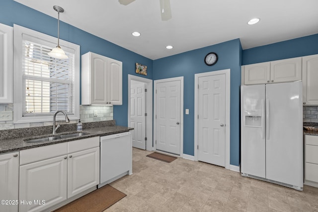 kitchen featuring white cabinets, decorative backsplash, sink, and white appliances