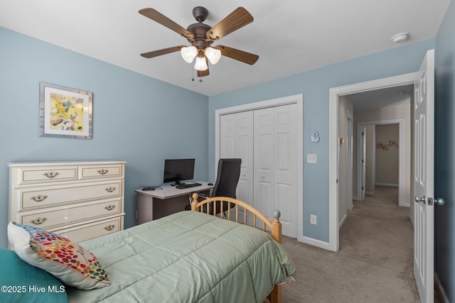 carpeted bedroom with ceiling fan and a closet