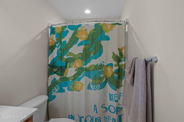 bathroom with toilet, vanity, and a shower with curtain