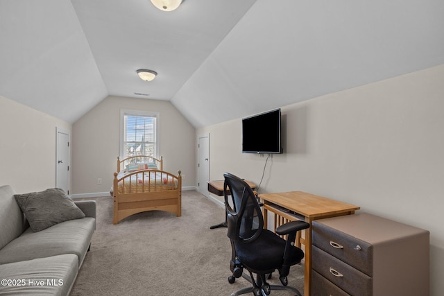 home office featuring light colored carpet and vaulted ceiling