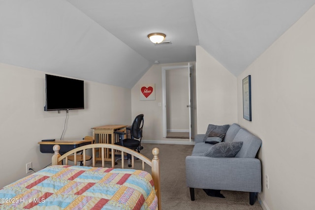 bedroom with lofted ceiling and carpet floors