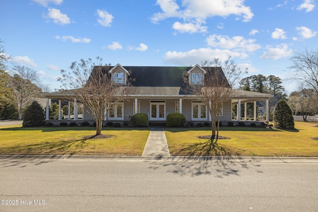 farmhouse inspired home with a front lawn and french doors