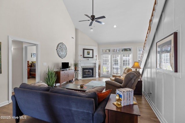 living room with ceiling fan, wood-type flooring, and high vaulted ceiling