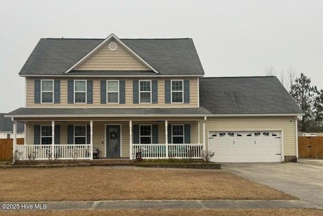 colonial home featuring a porch and a garage