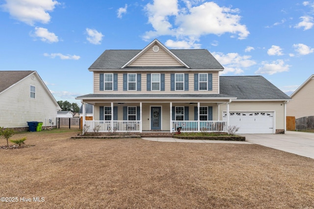 colonial home with a front yard, a porch, and a garage