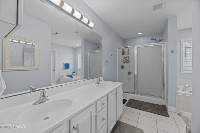 bathroom with tile patterned flooring, vanity, and shower with separate bathtub