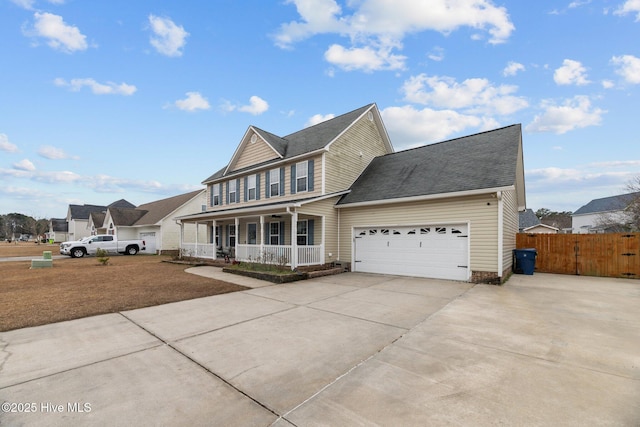 view of front of property featuring covered porch and a garage